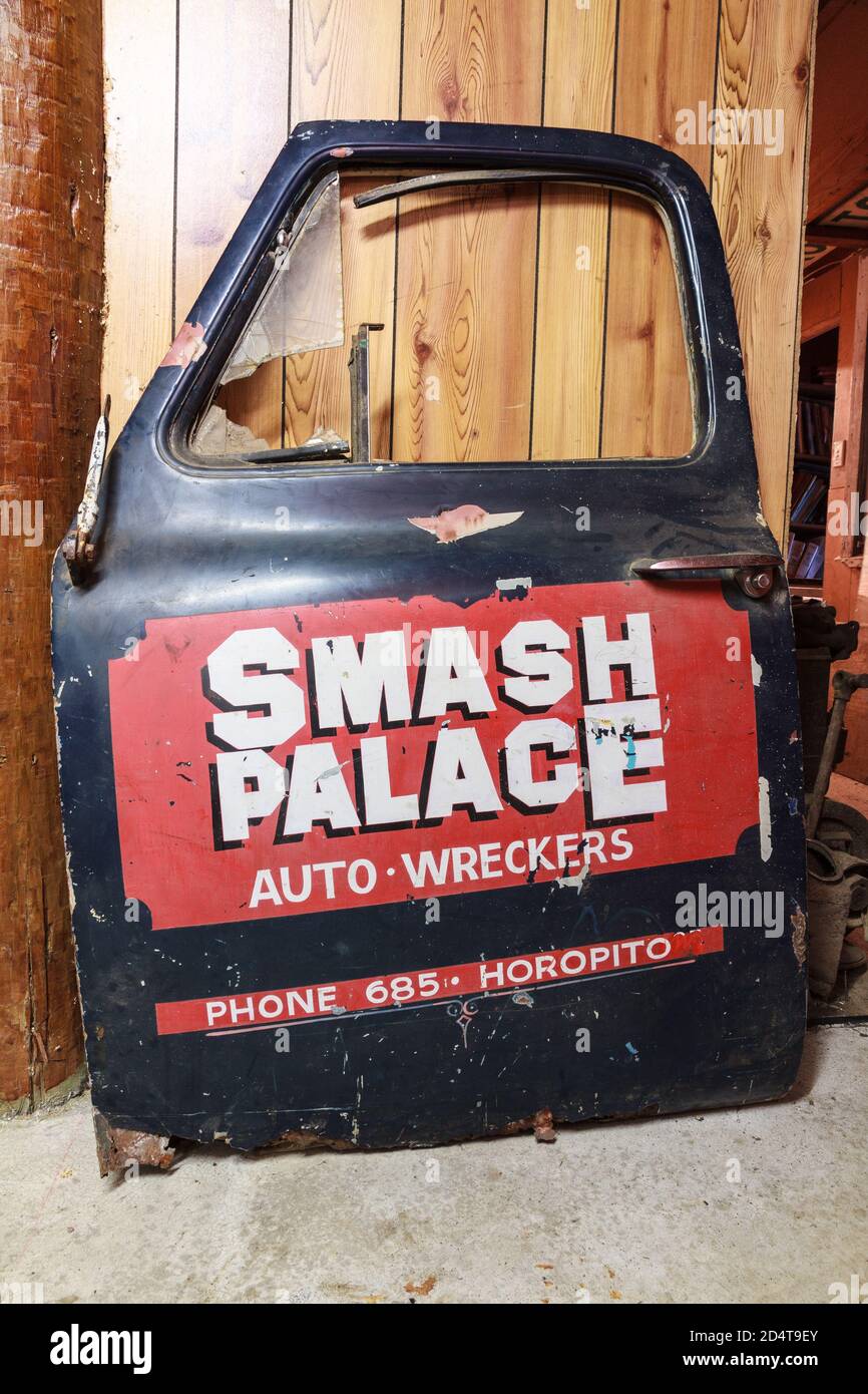 A car door with a retro advertisement for 'Smash Palace', a giant car wrecking yard in Horopito, New Zealand Stock Photo