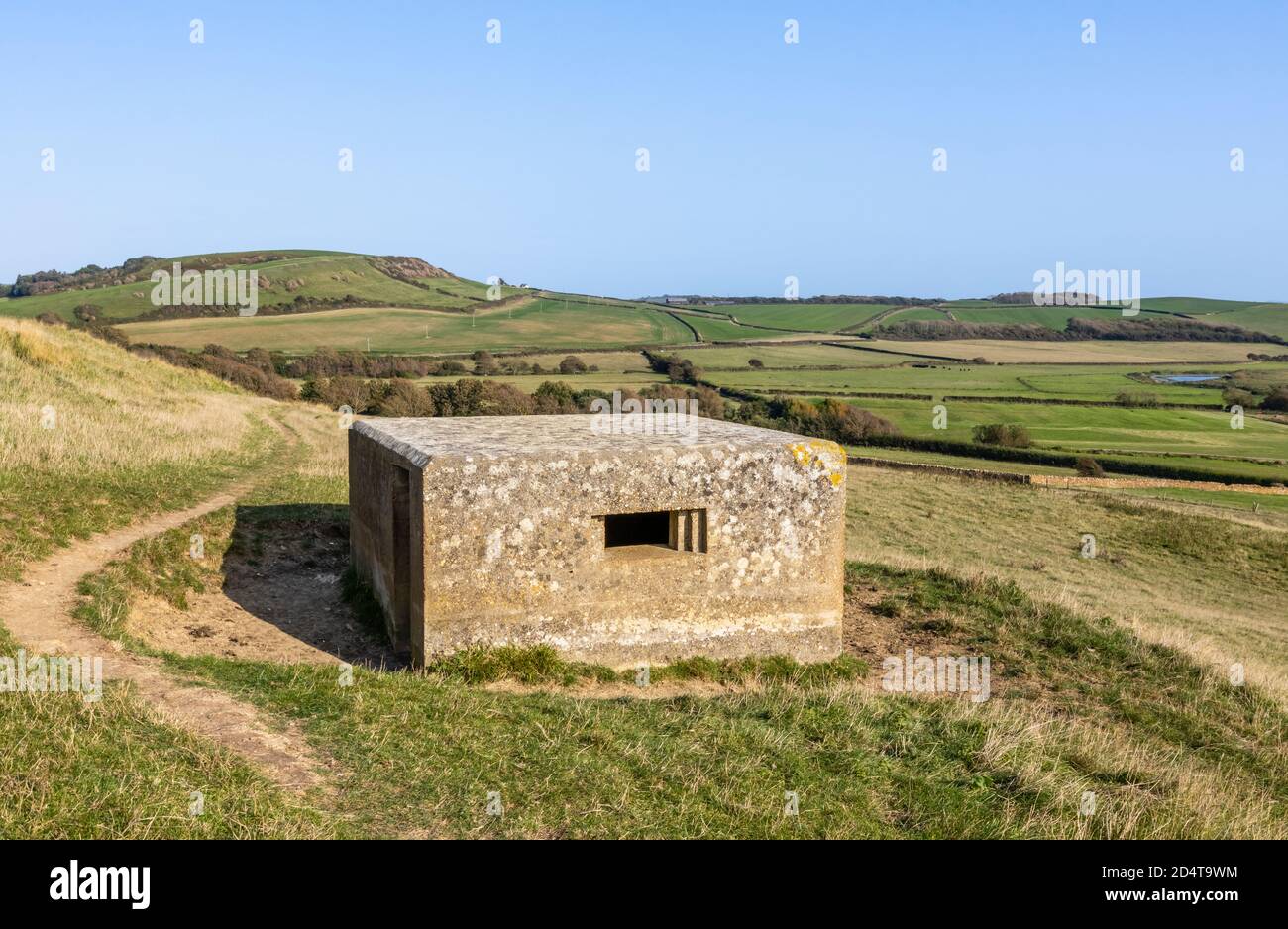 View of countryside with a clifftop pillbox, part of the Second World War coastal defences on the South-West Coast Path near Abbotsbury, Dorset, UK Stock Photo