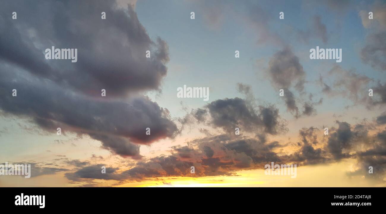 Sunset panorama. Nightly sky with clouds and sun stream Stock Photo - Alamy