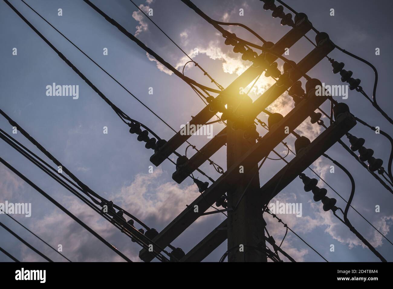High voltage distribution system consisting of a pole, shielded high voltage cable, insulators support high voltage cables. Stock Photo