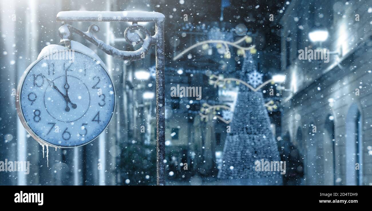 Vintage street clock in winter. New year time  Stock Photo