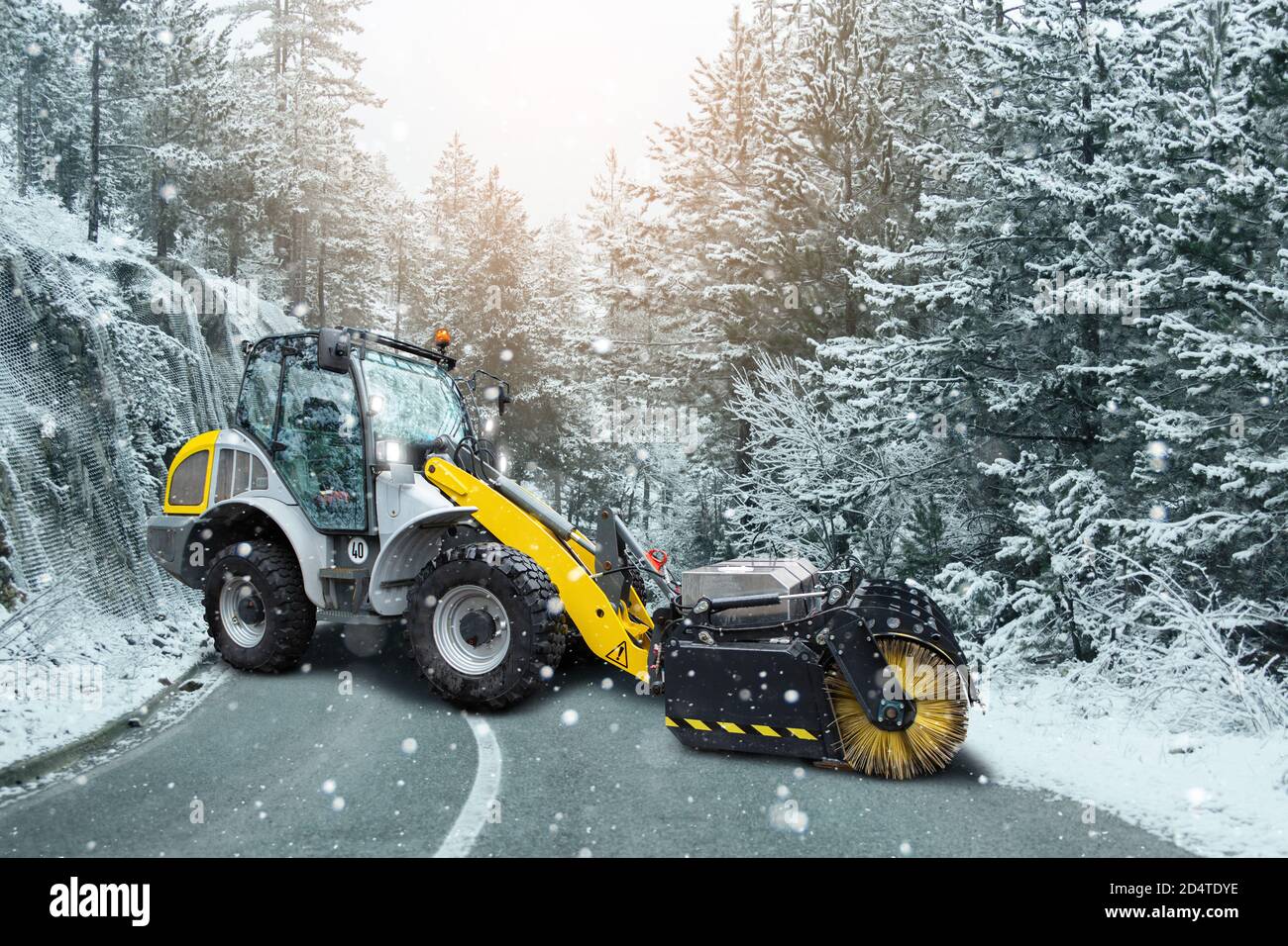 Snowblower machine for anti-icing treatment of winter road.  Stock Photo