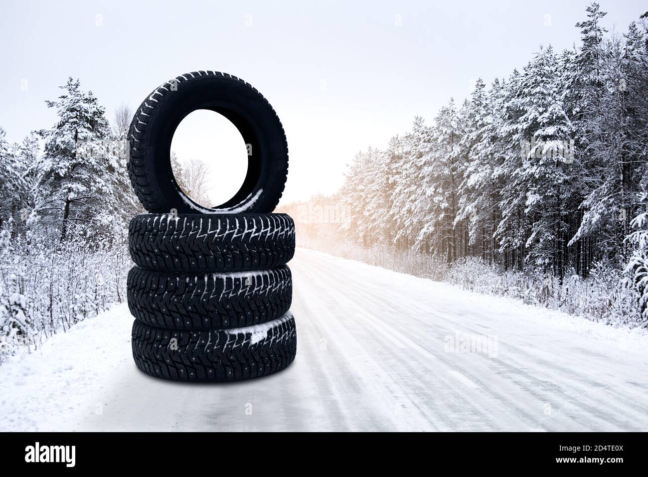 Winter tires on a snowy road. Seasonal tire change.  Stock Photo