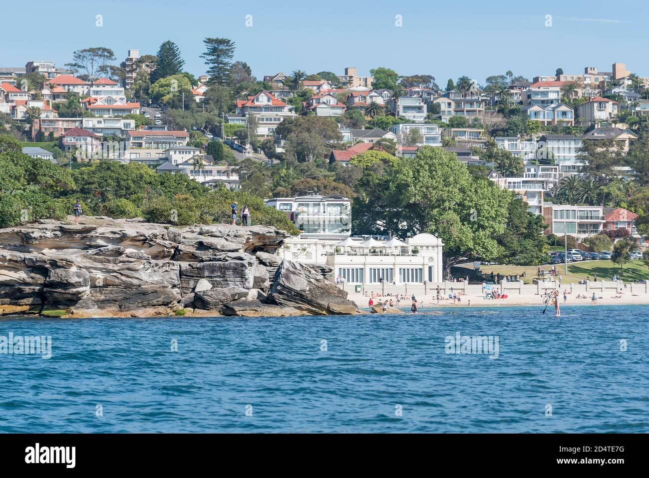 The 1928-29 constructed 'Spanish Mission' style, Bathers Pavilion at Balmoral Beach, Mosman, Sydney, Australia partially hidden by Rocky Point Island Stock Photo