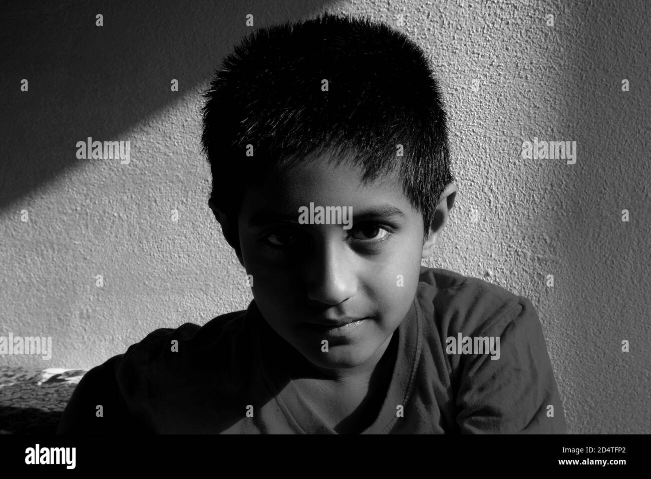a close head shot of Indian boy low key light in the morning monochrome photo, Kalaburagi, Karnataka/India-October 09 2020 Stock Photo