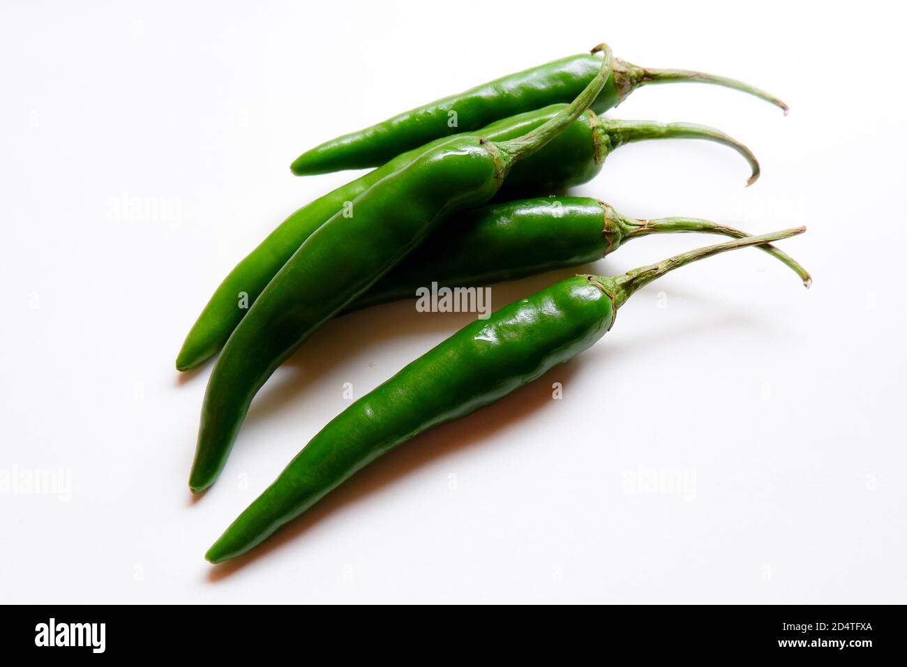 a top view of green chillies group isolated on white background Stock