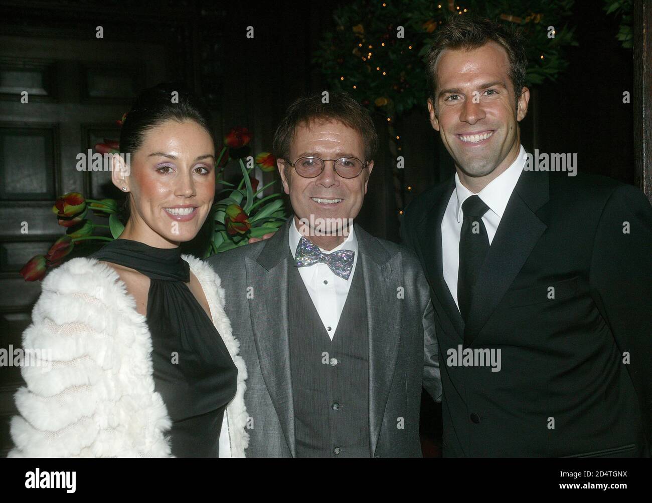 Cliff Richard's Tennis Foundation Dinner at Hampton Court 11th Dec 2003: Cliff Richard with Greg and Lucy Rusedski Stock Photo