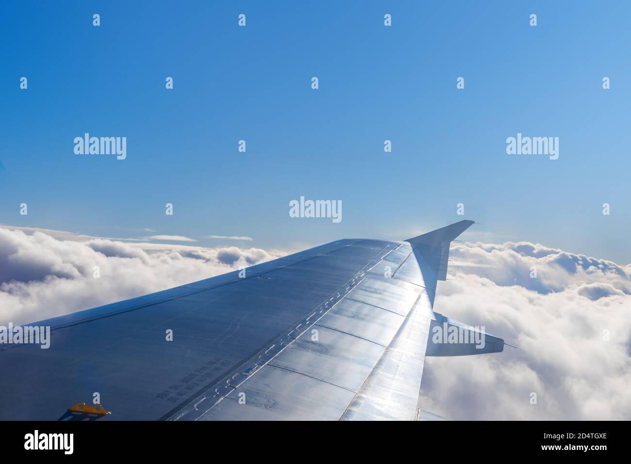 In Flight airplane wing above the clouds Stock Photo - Alamy