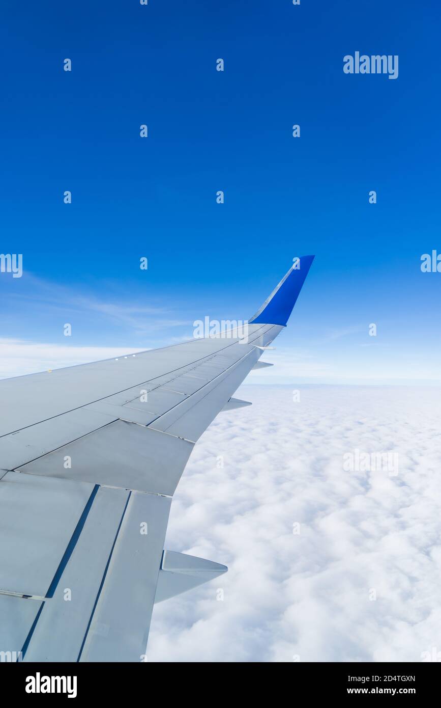 In Flight airplane wing above the clouds Stock Photo - Alamy