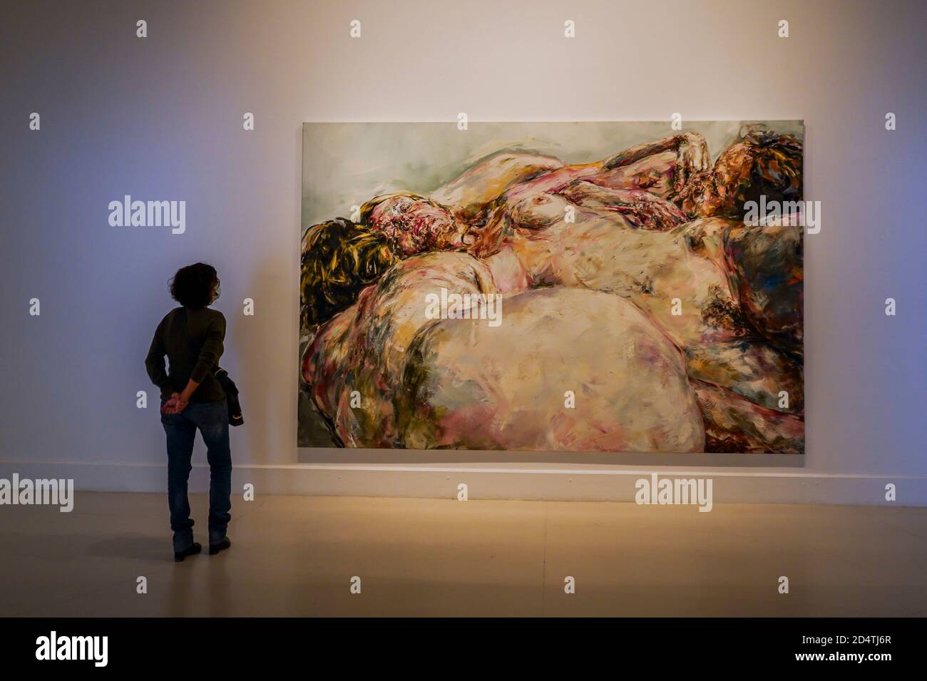 A visitor looking at painting of Philippe Pasqua. 'The Dark Side' his first solo exhibition, in the, CAC museum in Malaga, Andalusia, Stock Photo