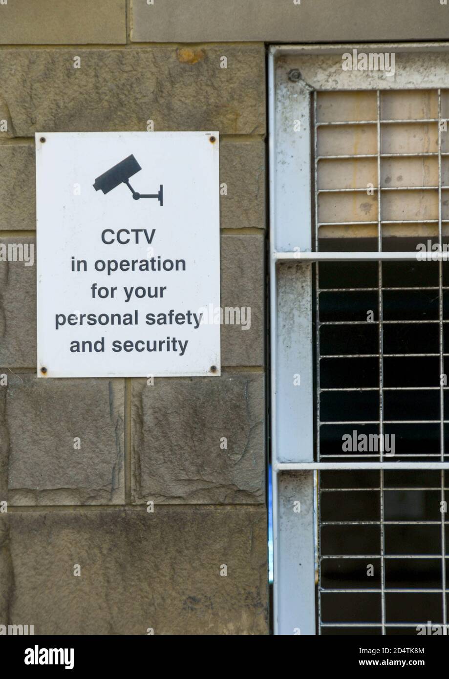 Sign on the wall of a car park building explaining CCTV is in operation. No people. Stock Photo