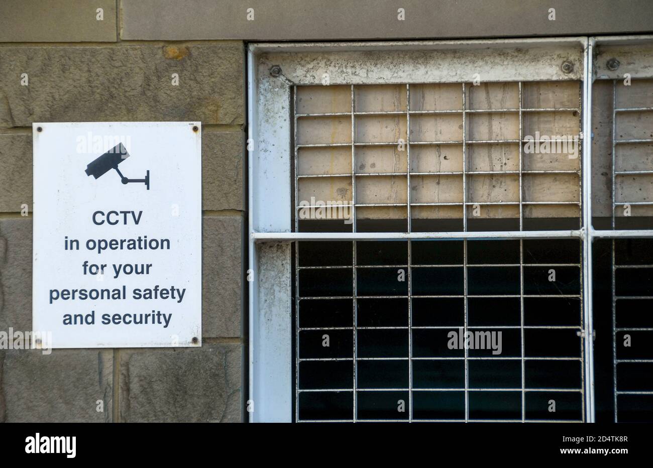 Sign on the wall of a car park building explaining CCTV is in operation. No people. Stock Photo