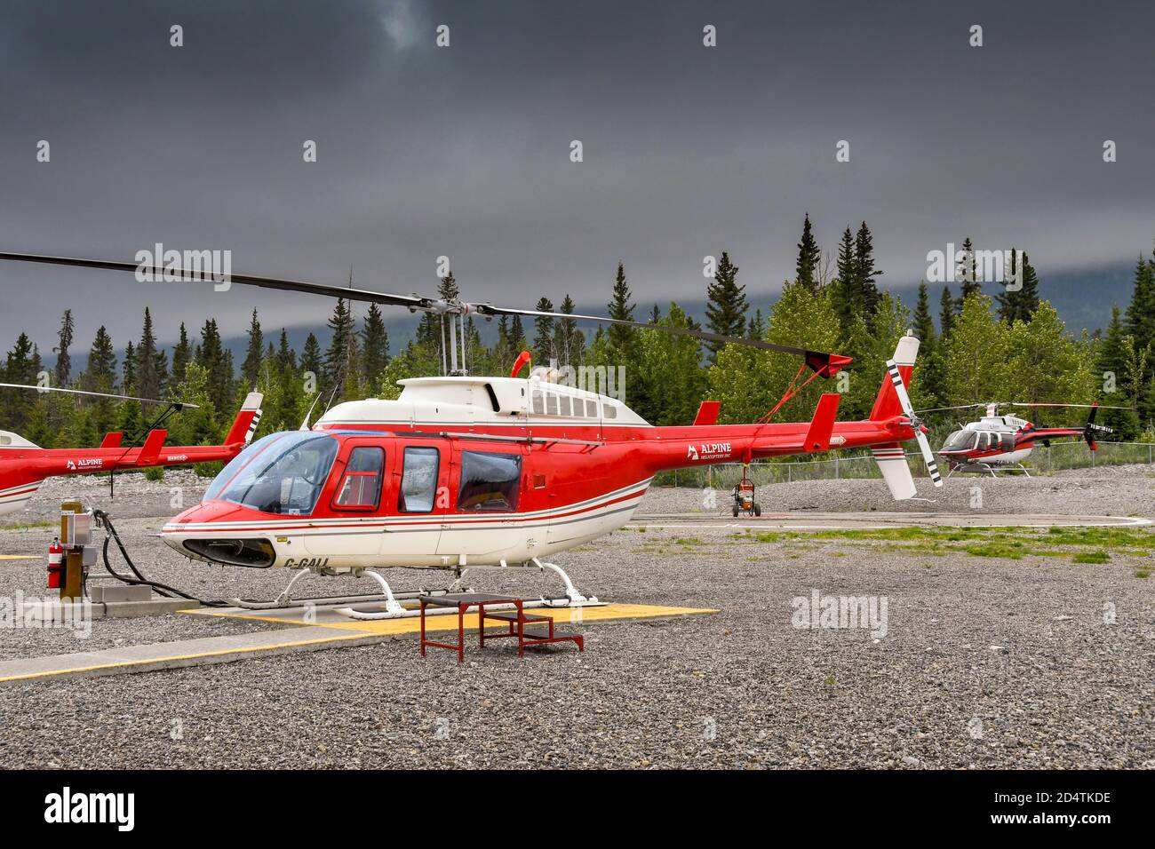 CANMORE, ALBERTA, CANADA - JUNE 2018: Helicopters lined up at the base of Alpine Helicopters in Canmore. Stock Photo