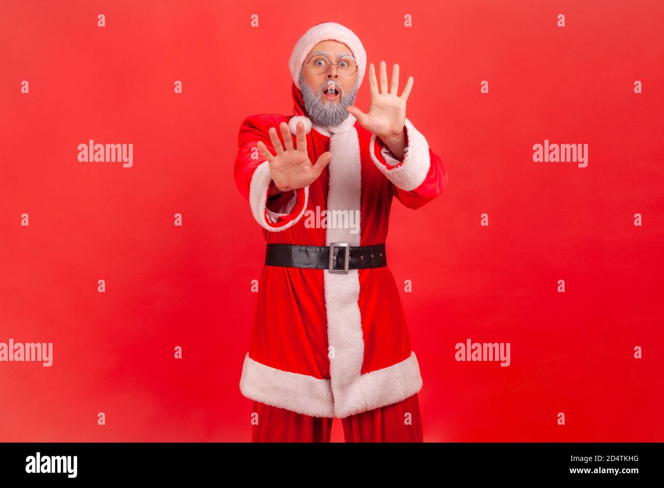 Portrait of worried frightened man in santa claus costume and