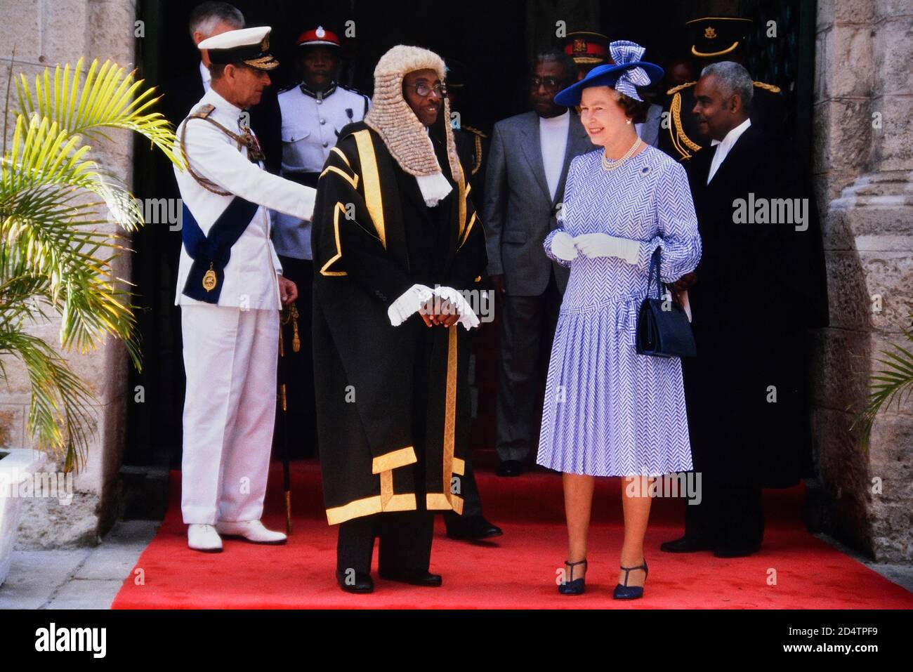 A smiling HM Queen Elizabeth II and Prince Philip accompanied by the Speaker of the House, Lawson Weekes, on a royal visit to mark the 350th anniversary of the Barbados Parliament, Bridgetown. 8-11th March 1989 Stock Photo