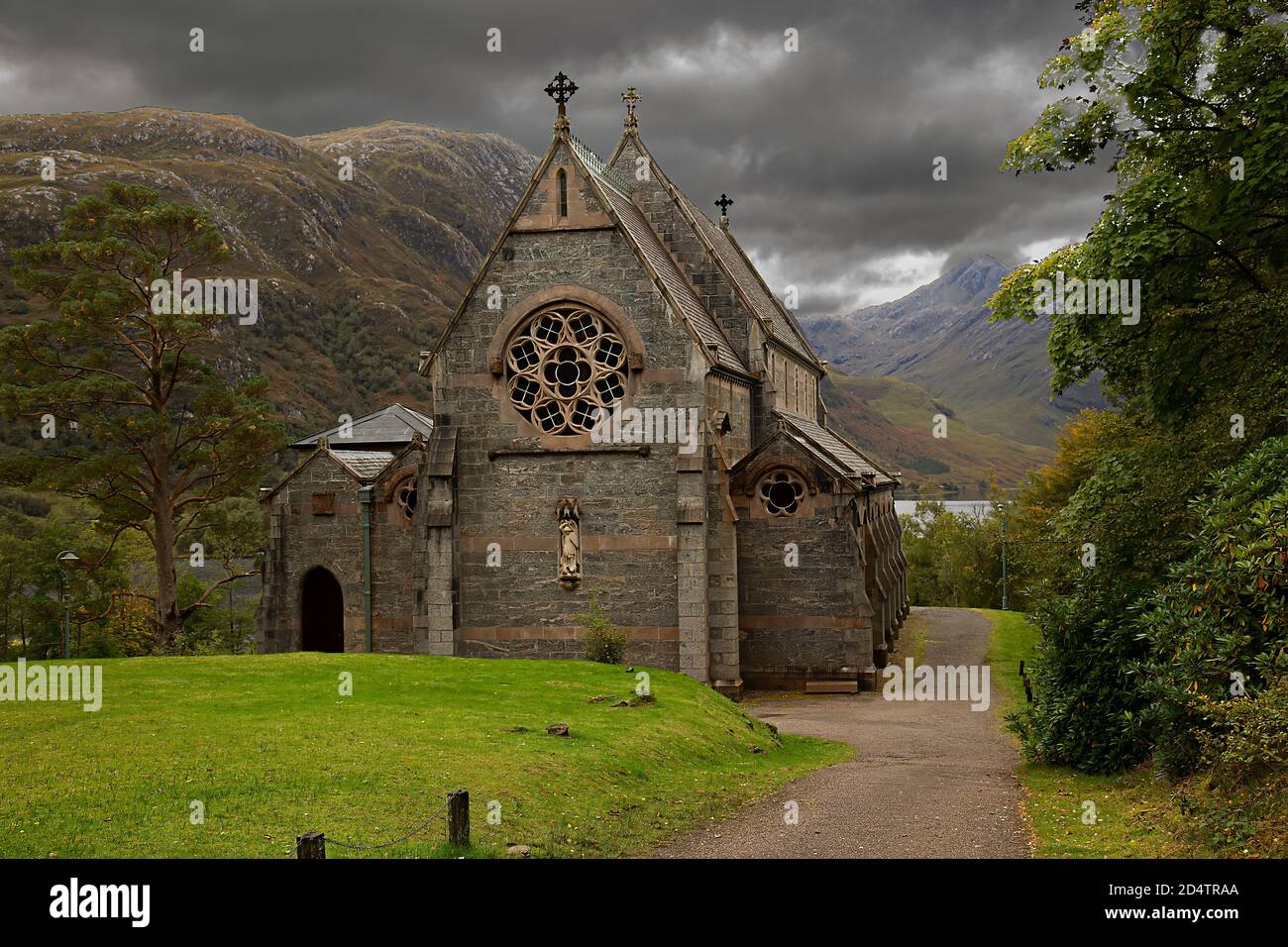 Ancient St Mary’s church in Glenfinnan Scotland with storm clouds in the sky. Stock Photo