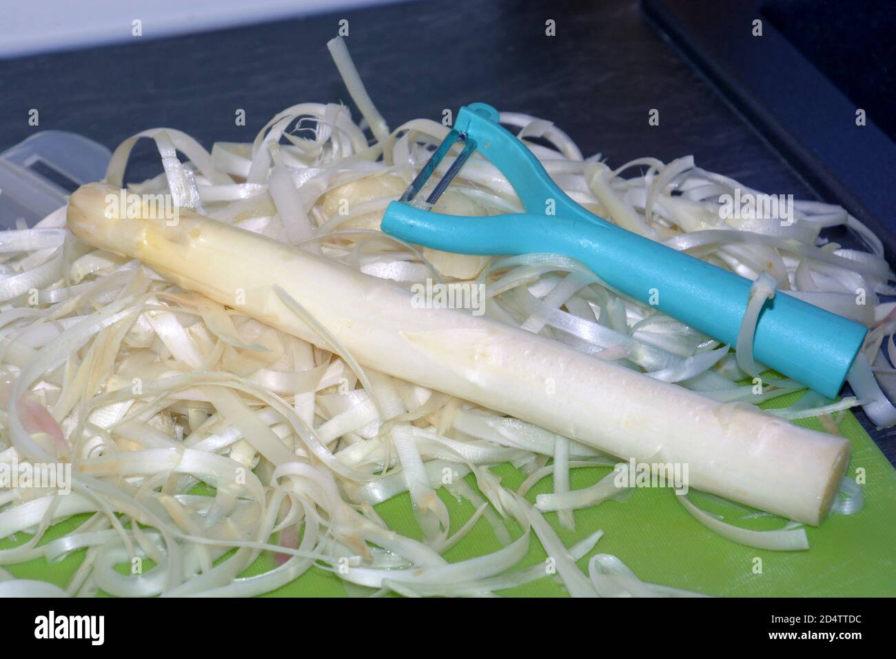 white asparagus peel and colorful peeler Stock Photo