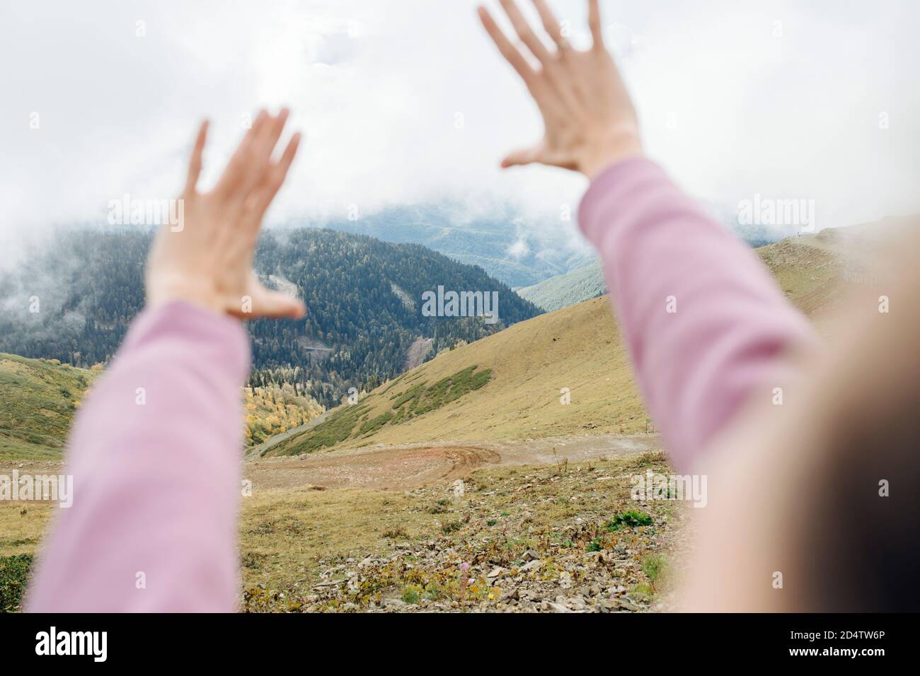 Point of view image of hands, taken high up in cloudy mountains Stock ...