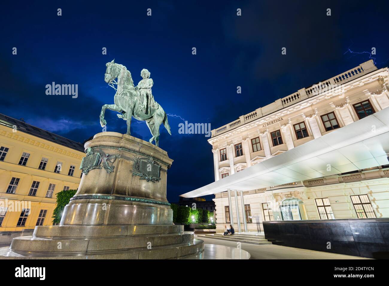 VIENNA - MAY 2: The Albertina building with lightning during a thunderstorm behind the Erzherzog Albrecht Statue at night in Austria on May 2, 2018. Stock Photo