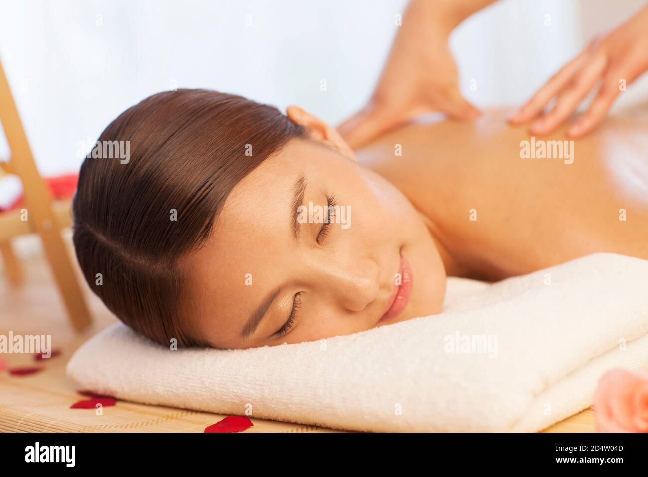 A person sitting on a bed Stock Photo