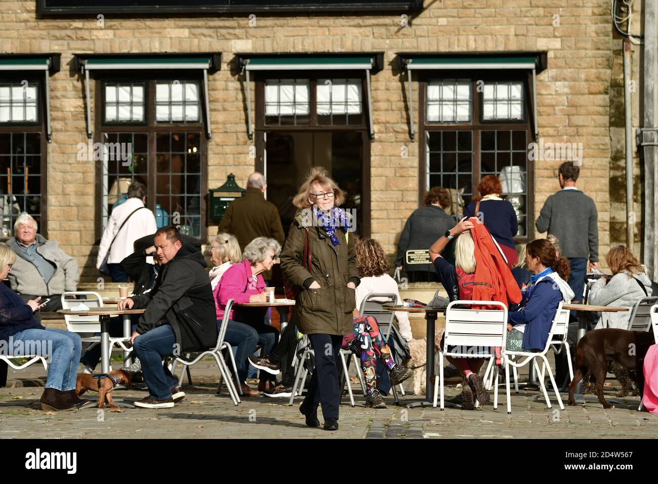 Wells, UK. 11th Oct, 2020. 11/October 2020. The New Normal, covid-19 eating out with red and white barriers separating people for social distancing at the City of Wells in Somerset on a warm and mild afternoon in October. Picture Credit: Robert Timoney/Alamy Live News Stock Photo