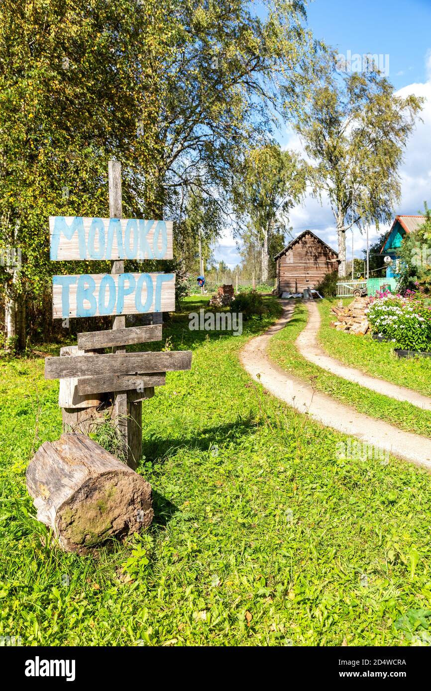 Homemade sign for the sale of milk and cottage cheese in a Russian village. Text in Russian: milk, curd Stock Photo