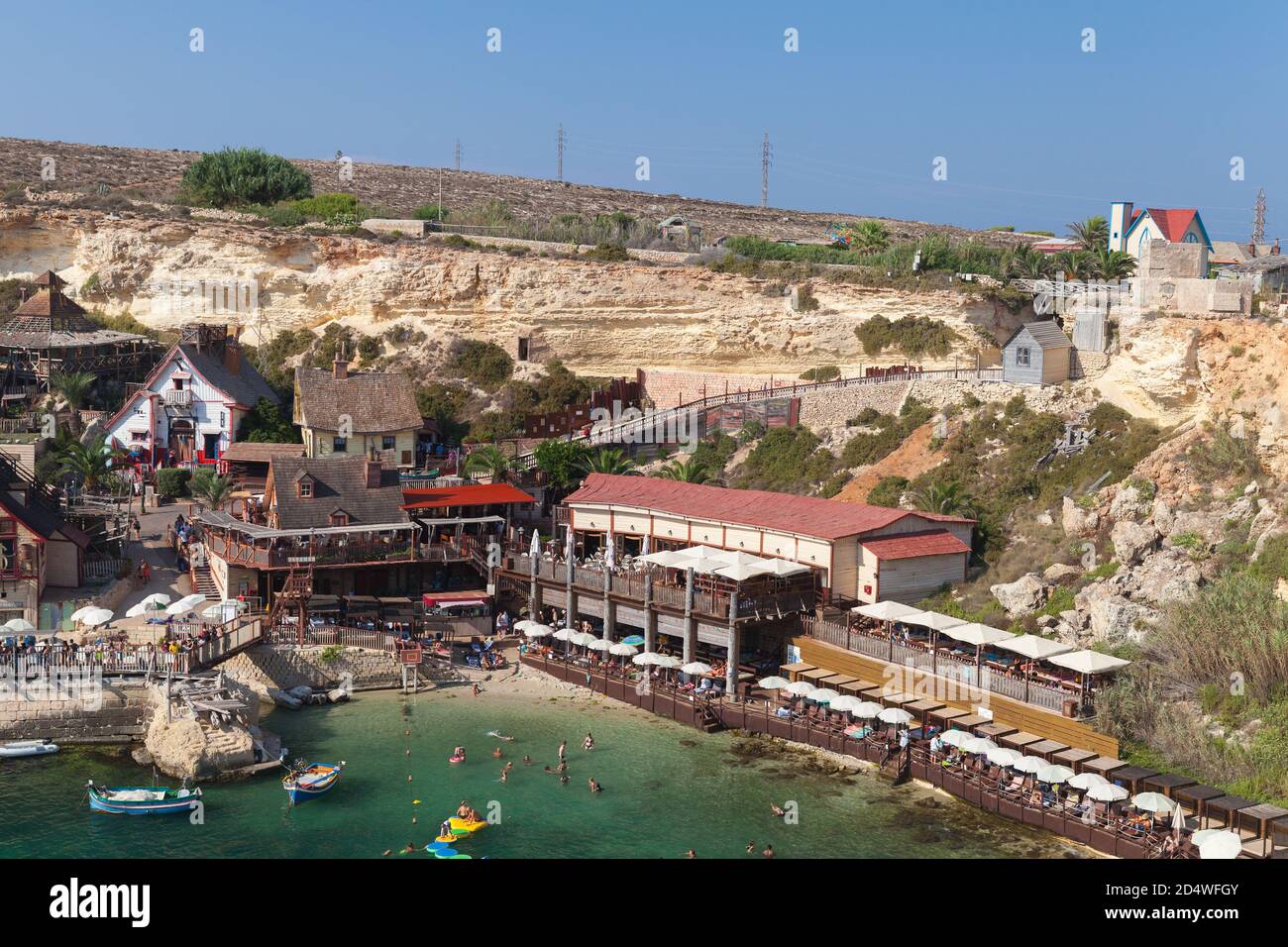 Mellieha, Malta - August 25, 2019: Coastal view of Popeye Village, also known as Sweethaven Village, purpose-built film set village that has been conv Stock Photo