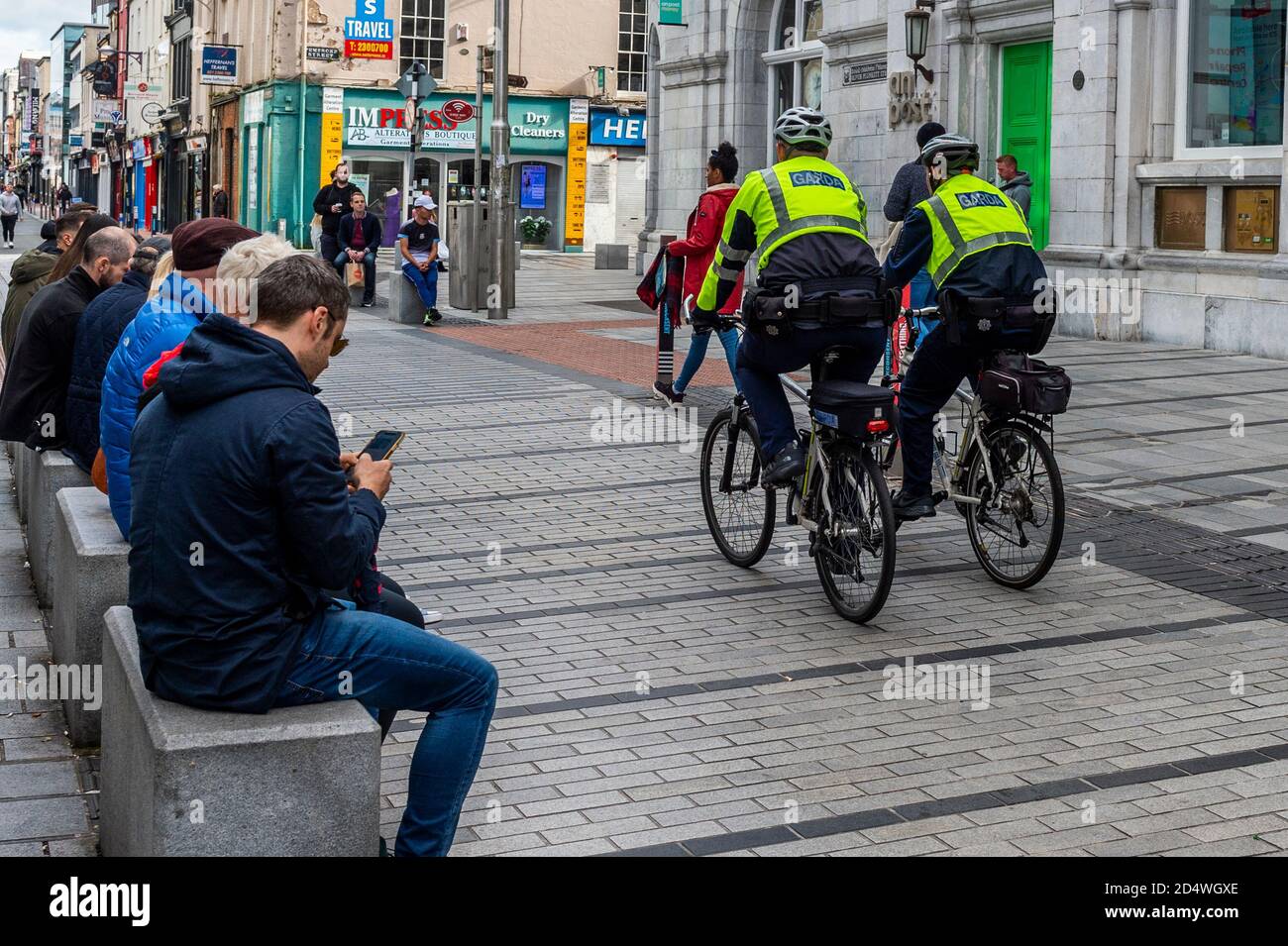 Cork, Ireland. 11th Oct, 2020. Gardai on push bikes patrol Oliver Plunkett Street in Cork city today amidst COVID-19 Level 3 restrictions. Credit: AG News/Alamy Live News Stock Photo