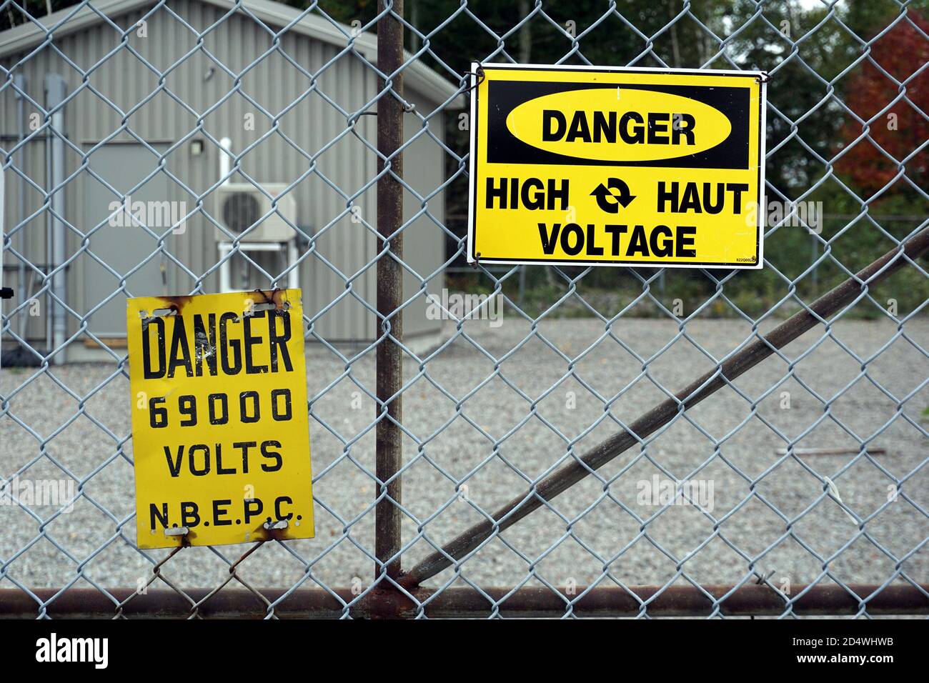 High voltage warning signs on an electrical sub station gate Stock Photo