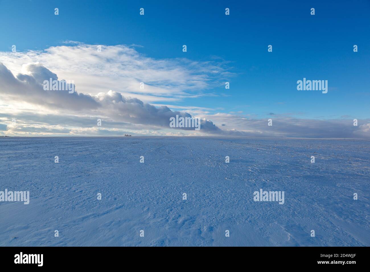 Winter snow-covered field and blue sky with clouds Stock Photo - Alamy