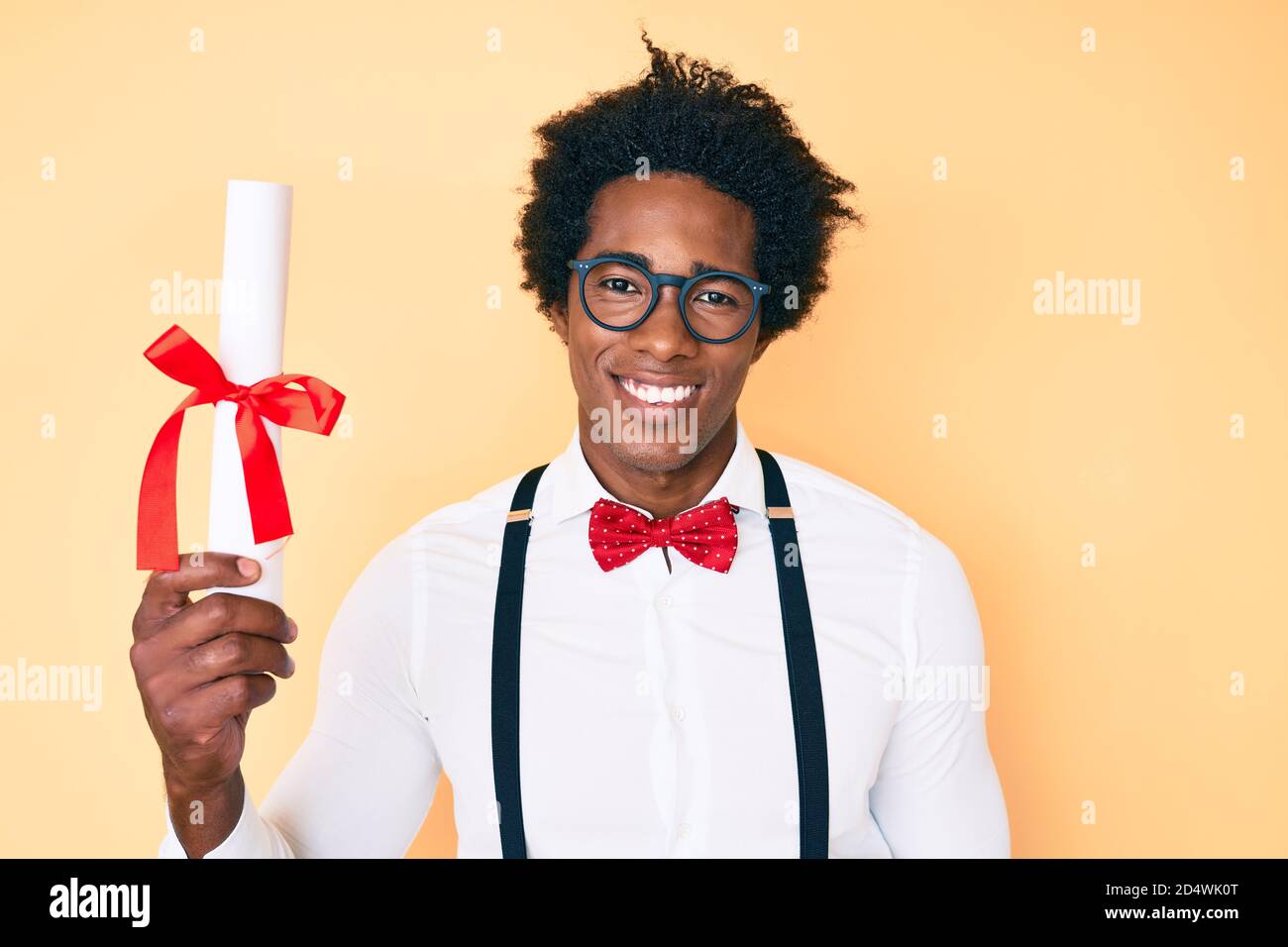 Handsome african american nerd man with afro hair holding graduate ...