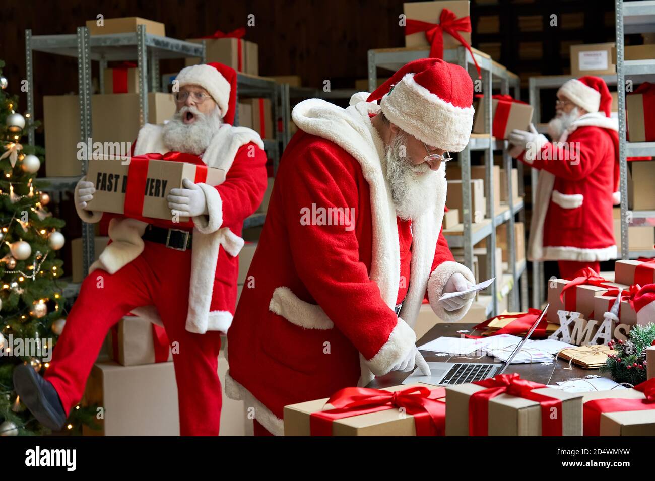 Many Santa Clauses packing presents gift boxes preparing fast xmas