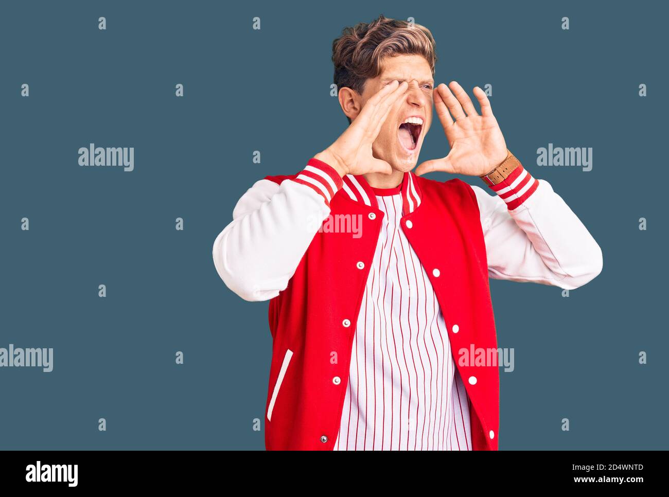 Shouting Baseball Young handsome man wearing baseball uniform shouting angry out loud ...