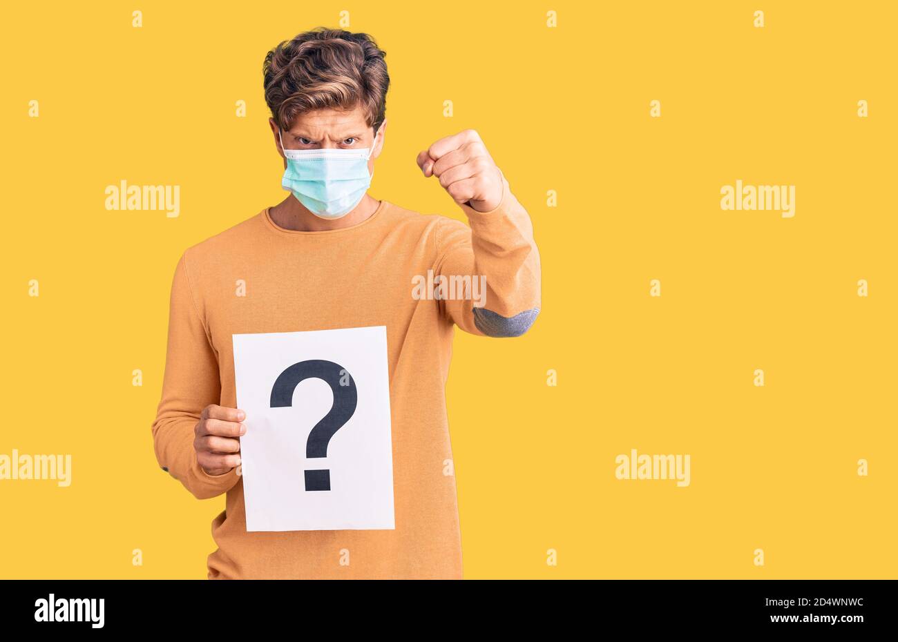 Question Mask Man Young handsome man wearing medical mask holding question mark annoyed ...