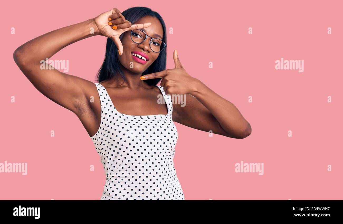 Young african american woman wearing casual clothes and glasses smiling ...