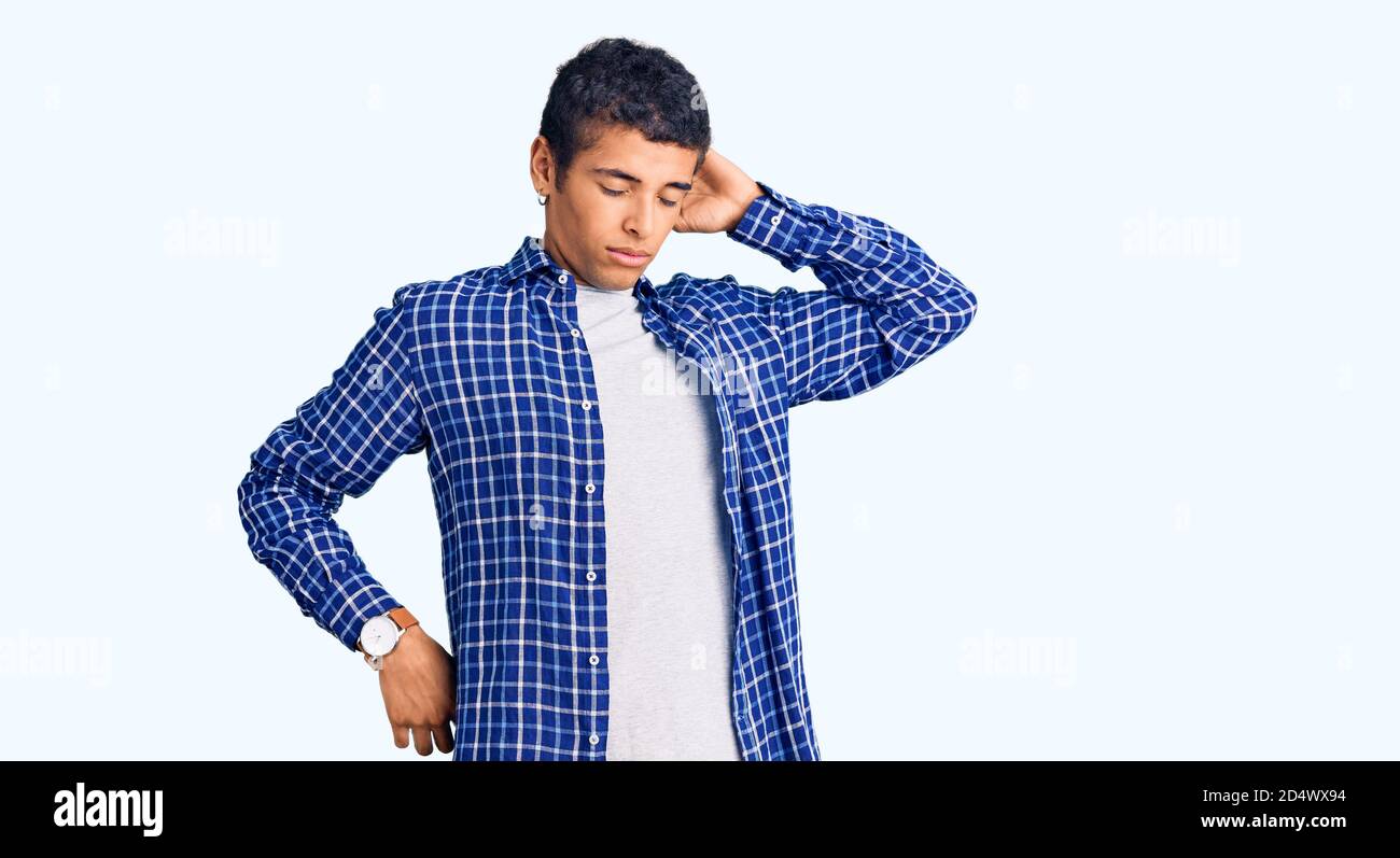 Young african amercian man wearing casual clothes stretching back, tired and relaxed, sleepy and yawning for early morning Stock Photo