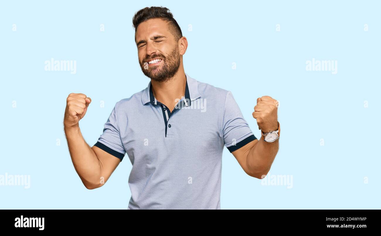 Handsome man with beard wearing casual clothes very happy and excited ...