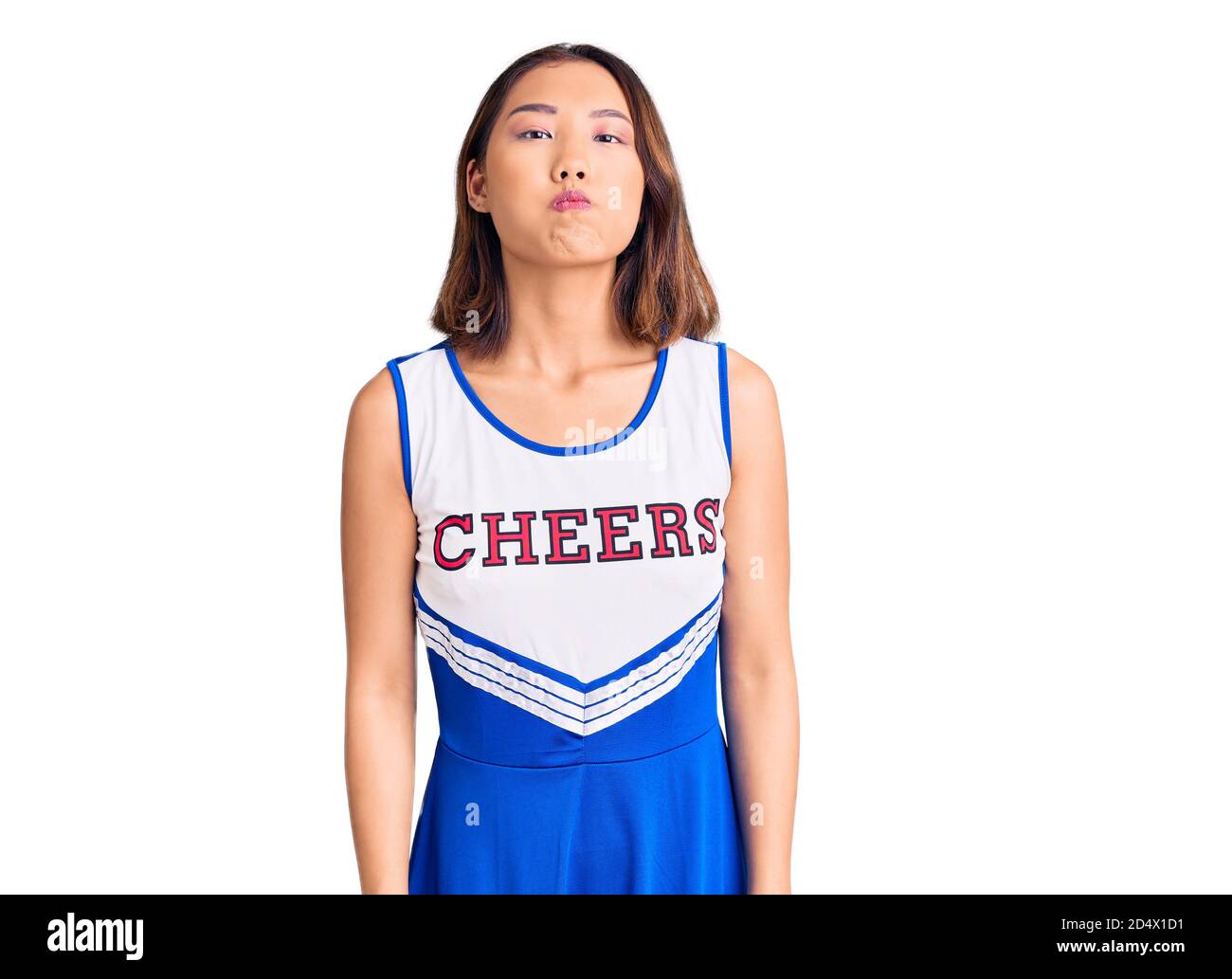 Young Beautiful Chinese Girl Wearing Cheerleader Uniform Puffing Cheeks
