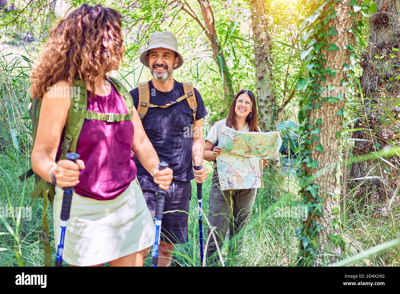 Family smiling happy hiking at the forest Stock Photo - Alamy
