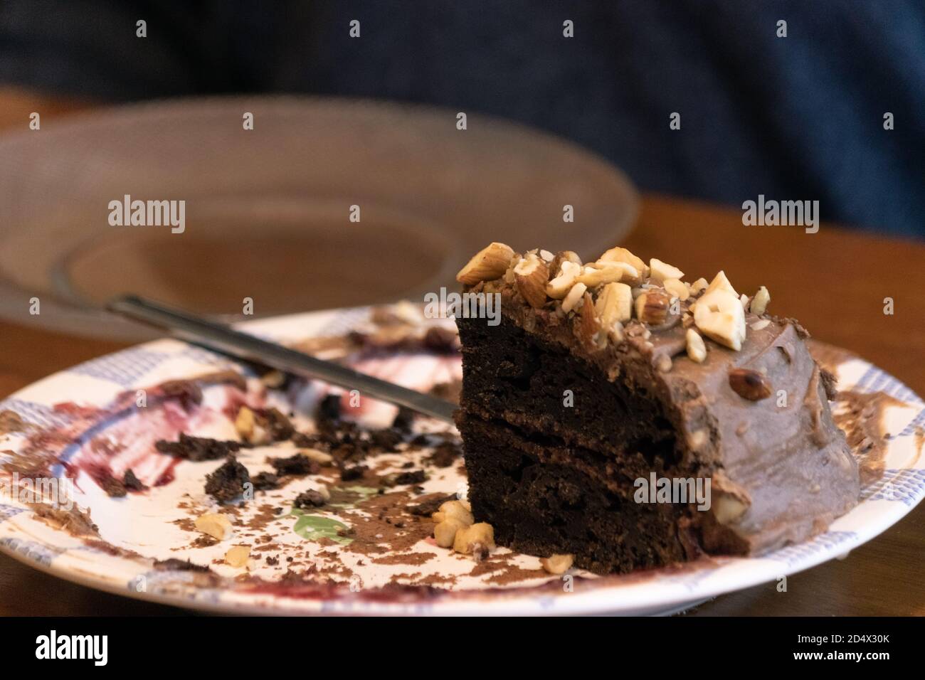 Elderly woman preparing and enjoying baked goods in a kitchen Stock Photo