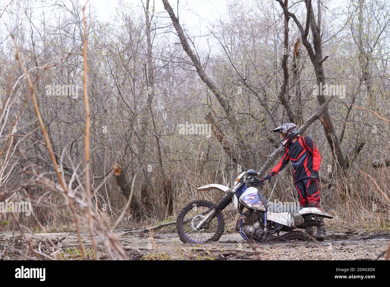 Motorbike racer with his vehicle stuck in mud Stock Photo Alamy