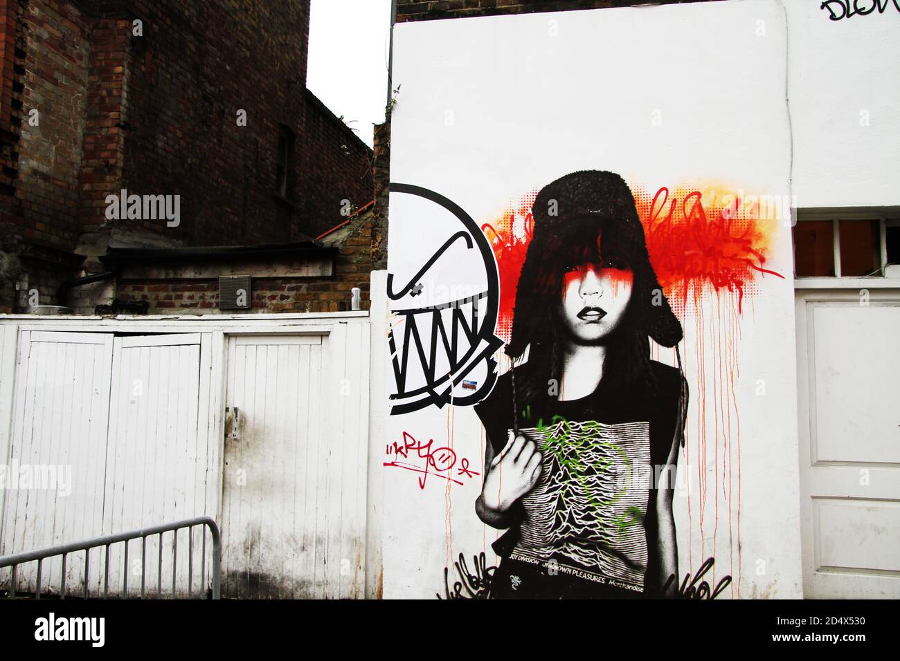 Street Art in North London of girl wearing Joy Division Shirt Stock Photo -  Alamy