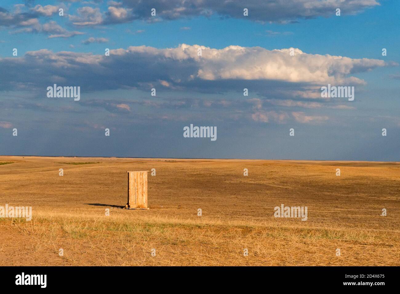 Isolated old cabin on farmland with blue cloudly sky Stock Photo - Alamy