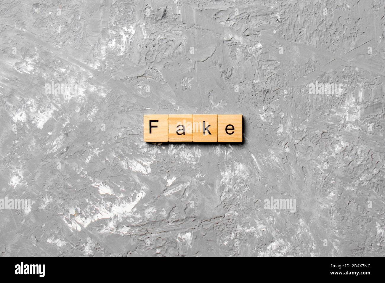 Fake word written on wood block. Fake text on cement table for your