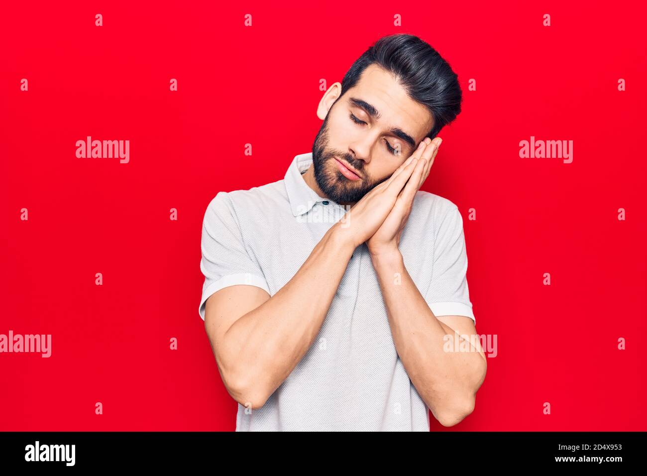 Young handsome man with beard wearing casual polo sleeping tired ...