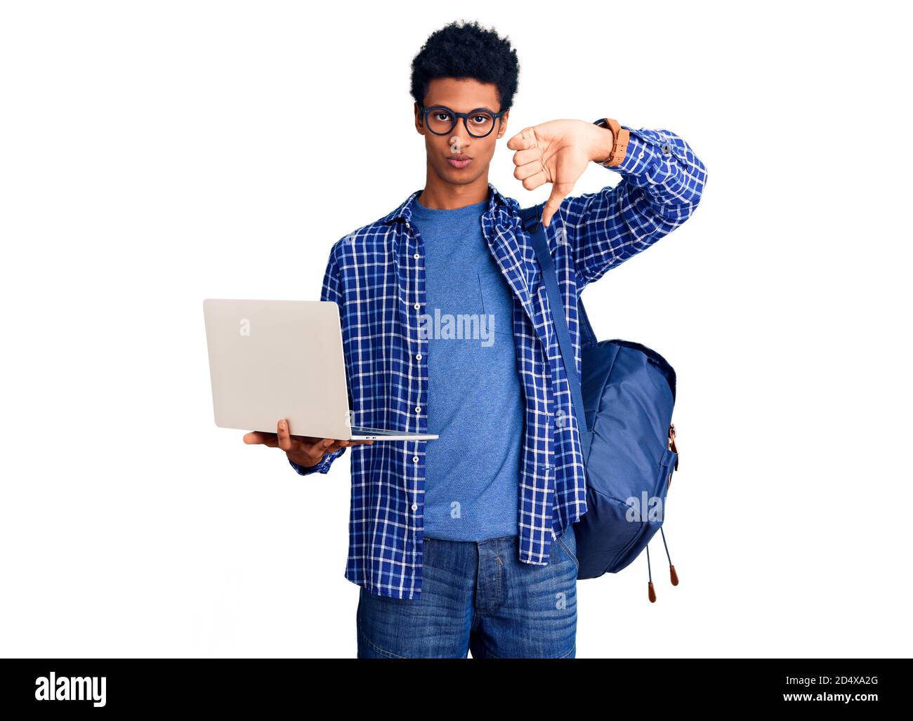 Young african american man holding student backpack using laptop with ...