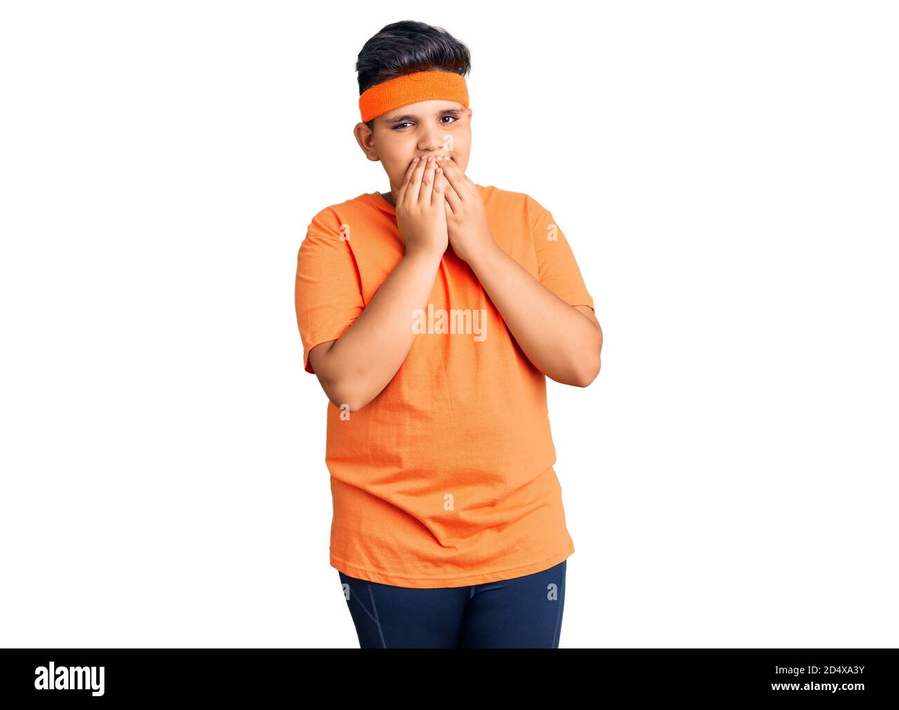 Little boy kid wearing sportswear laughing and embarrassed giggle covering mouth with hands, gossip and scandal concept Stock Photo