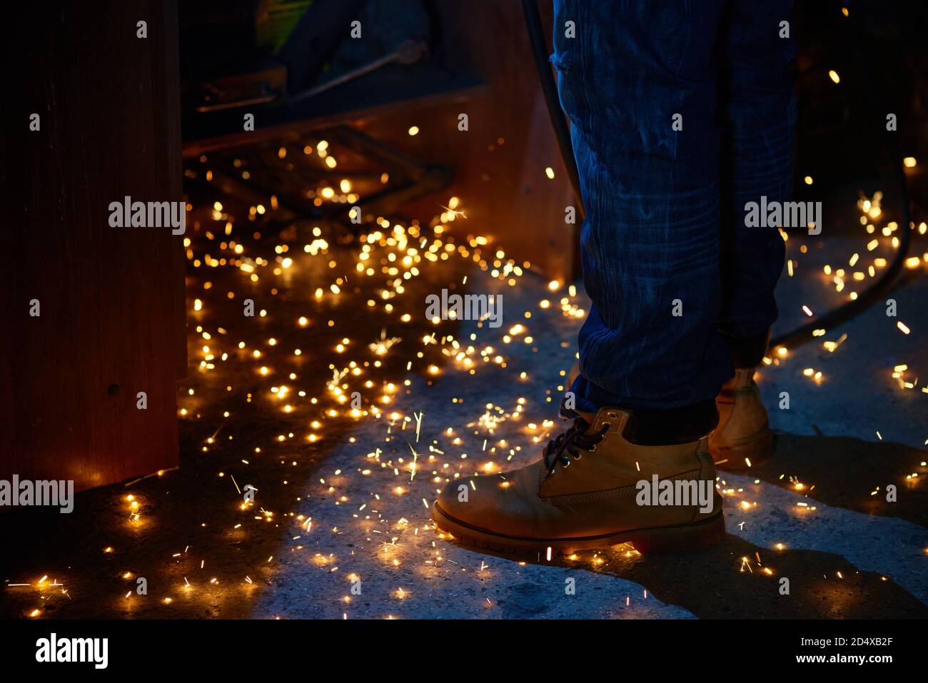 Welding arcs and sparks falling down in repairman workshop Stock Photo