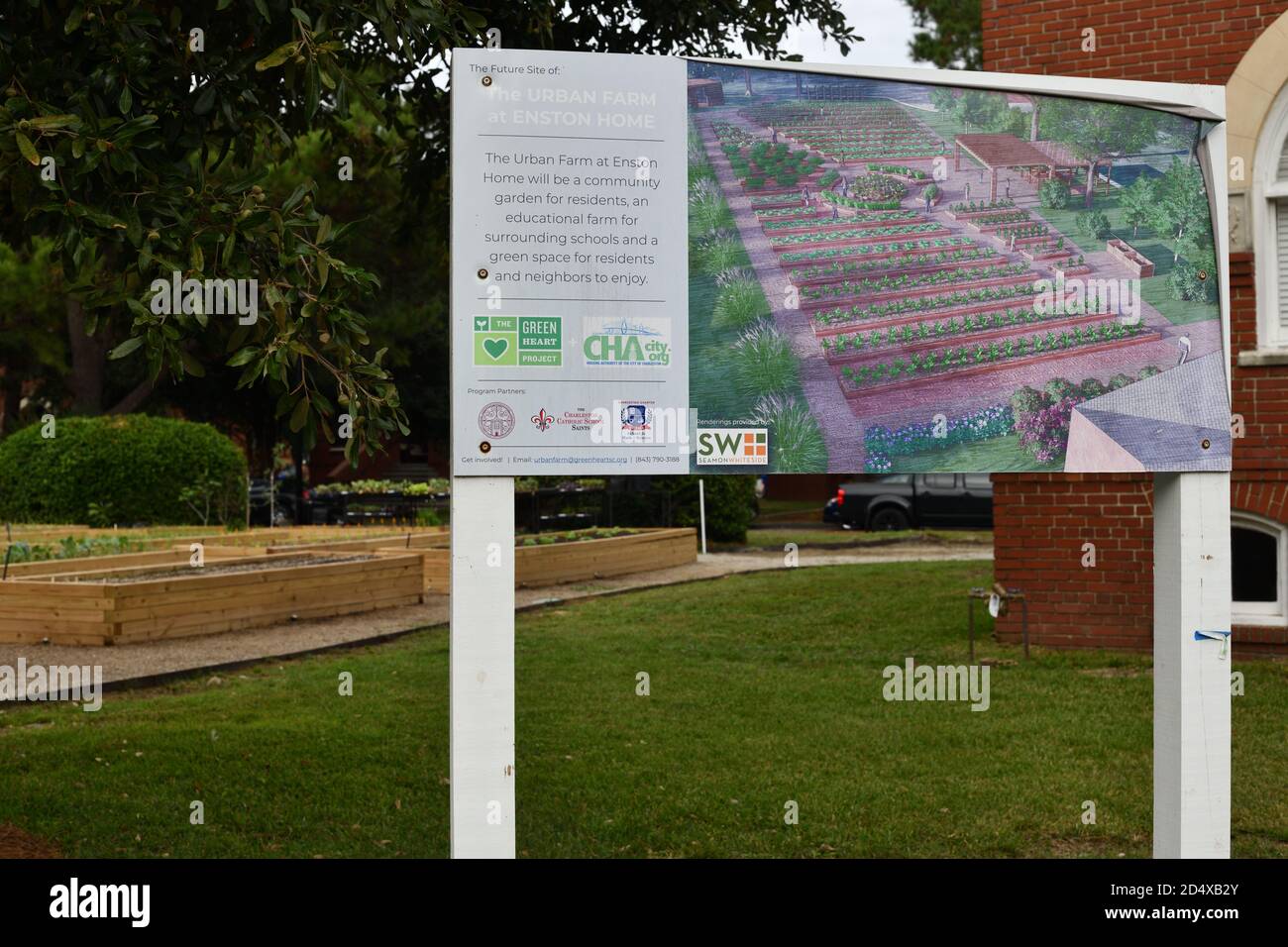 Urban Gardens as a 19th Century English Village with Soil Plots Set Against English Street Names and Red Brick Architecture with New Plants Growing. Stock Photo