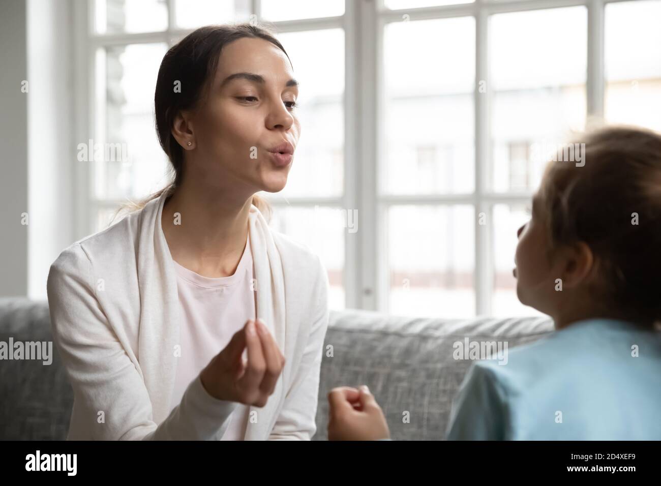 Caucasian speech therapist teach little girl pronunciation Stock Photo